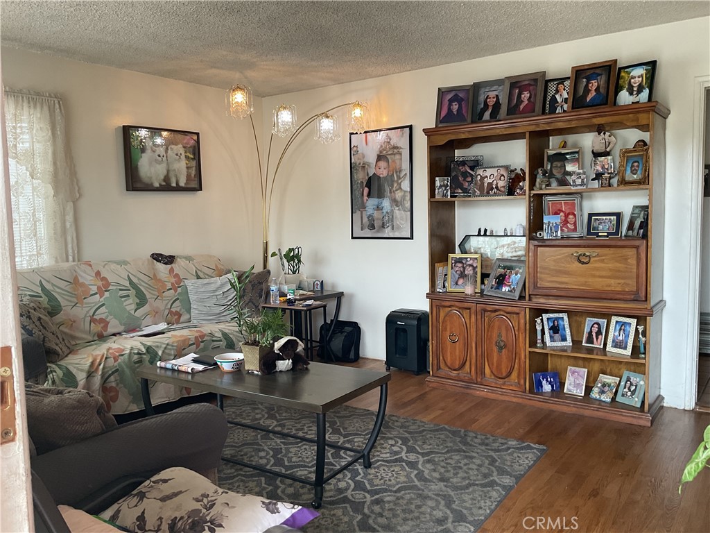 5007 Astor Avenue Commerce, CA 90040 - Photo 18 of 64 a living room with furniture and book shelf