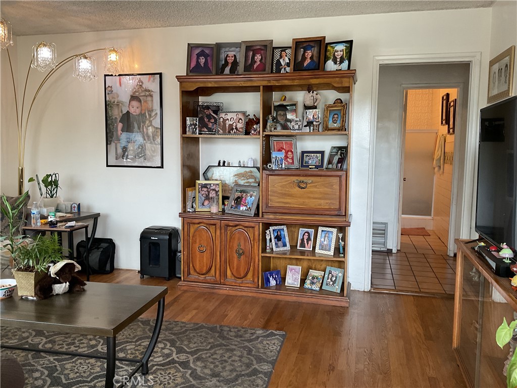 5007 Astor Avenue Commerce, CA 90040 - Photo 22 of 64 a living room with furniture and a book shelf
