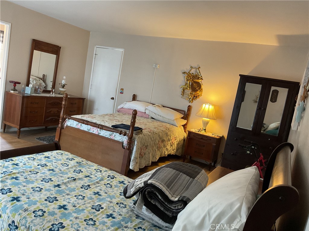 5007 Astor Avenue Commerce, CA 90040 - Photo 27 of 64 a bedroom with a bed and wooden floor