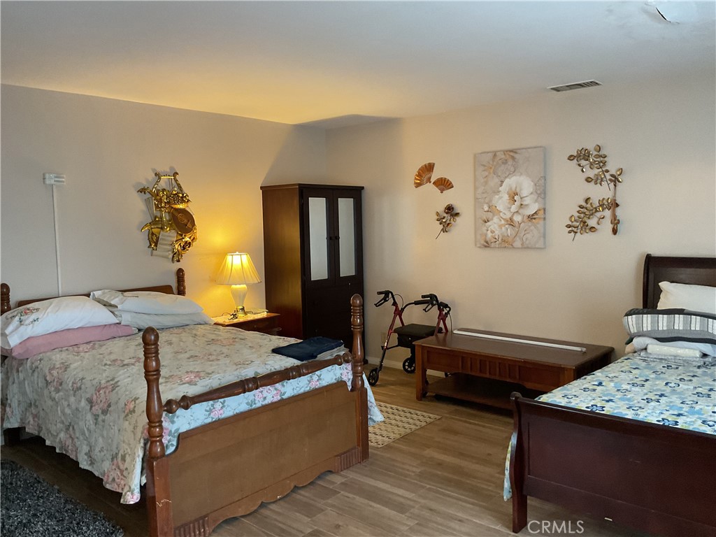 5007 Astor Avenue Commerce, CA 90040 - Photo 29 of 64 a bedroom with 2 bed and a table in it