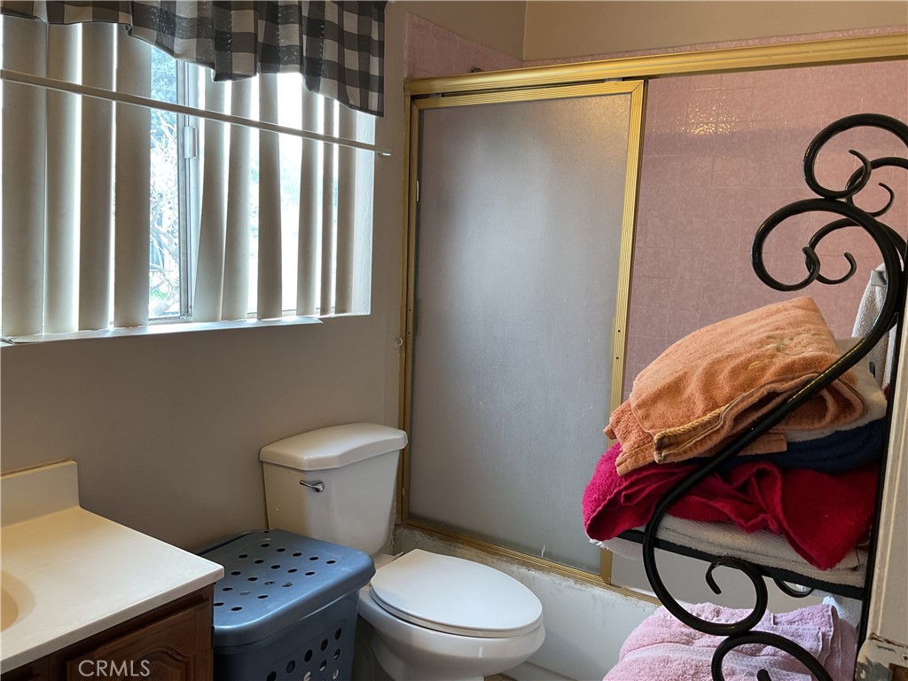 5007 Astor Avenue Commerce, CA 90040 - Photo 33 of 64 a bathroom with a toilet a sink and a shower