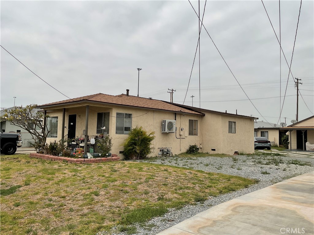 5007 Astor Avenue Commerce, CA 90040 - Photo 4 of 64 a front view of a house with garden