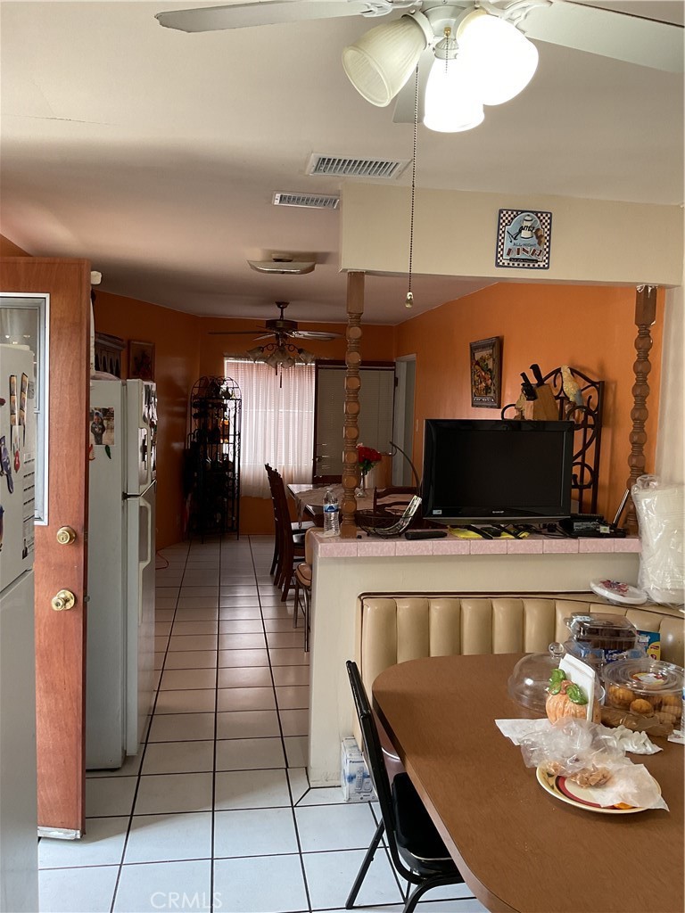 5007 Astor Avenue Commerce, CA 90040 - Photo 43 of 64 a kitchen with a dining table and chairs