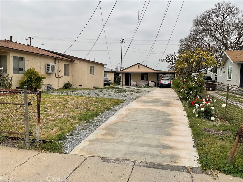 5007 Astor Avenue Commerce, CA 90040 - Photo 5 of 64 a front view of a house with a yard