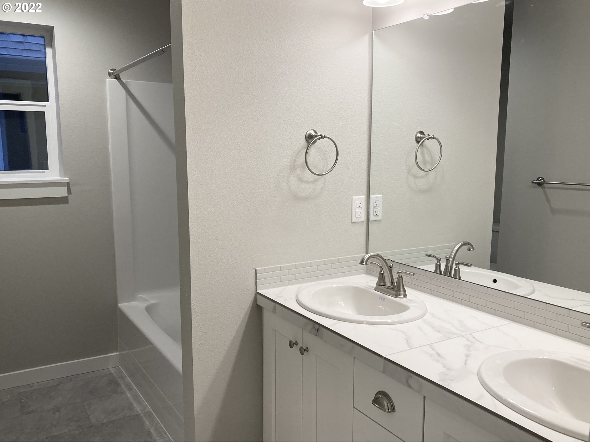 7315 South 13th Street Ridgefield, WA 98642 - Photo 8 of 11 a bathroom with a sink and a mirror