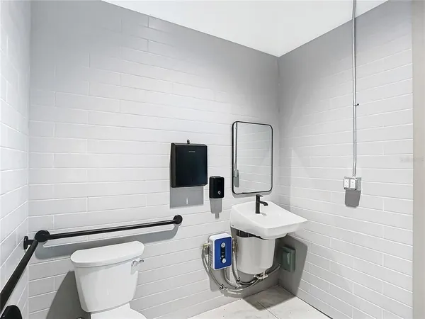 a bathroom with a sink toilet and mirror