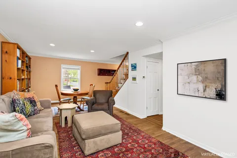 a living room with furniture and wooden floor