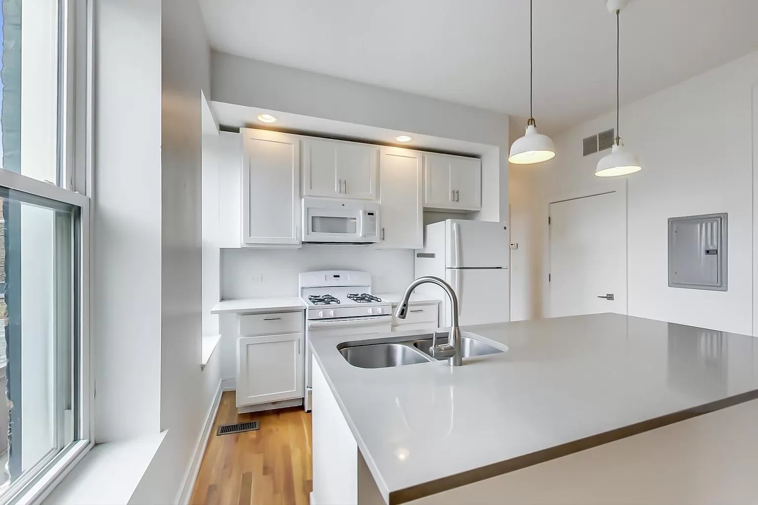 1157 West 18th Street Chicago, IL 60608 - Photo 2 of 8 a kitchen with kitchen island a sink appliances and cabinets