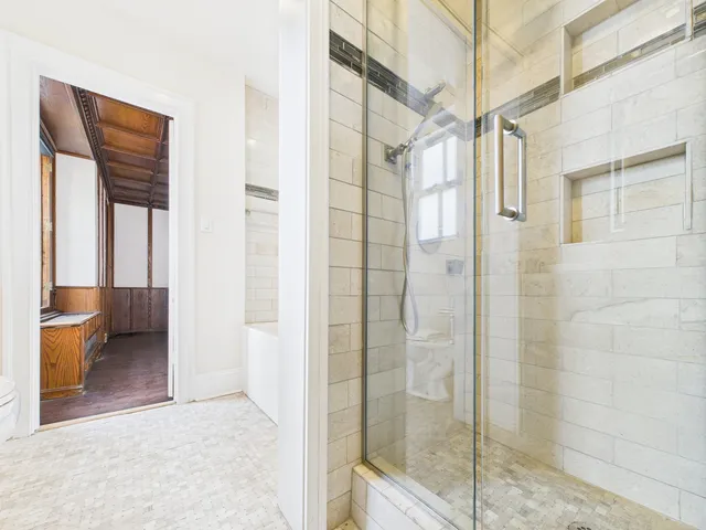 a view of an empty room with wooden floor and closet