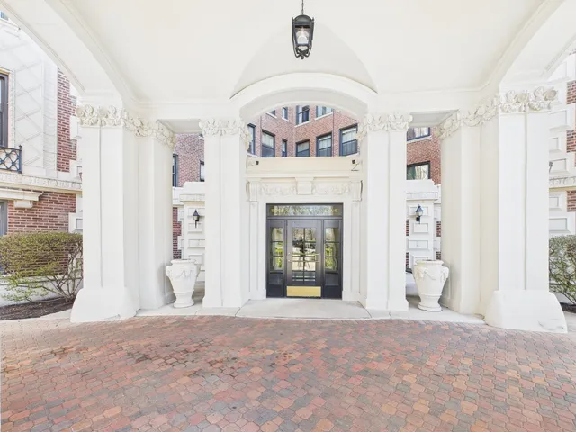 a view of a hallway with a white walls and stairs