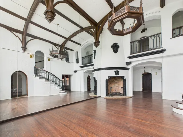 a view of a fireplace with windows and wooden floor