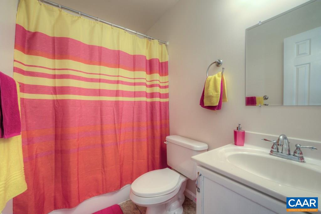 11 Buttercup Road Ruckersville, VA 22968 - Photo 20 of 30 a white toilet sitting next to a bathroom sink and a mirror