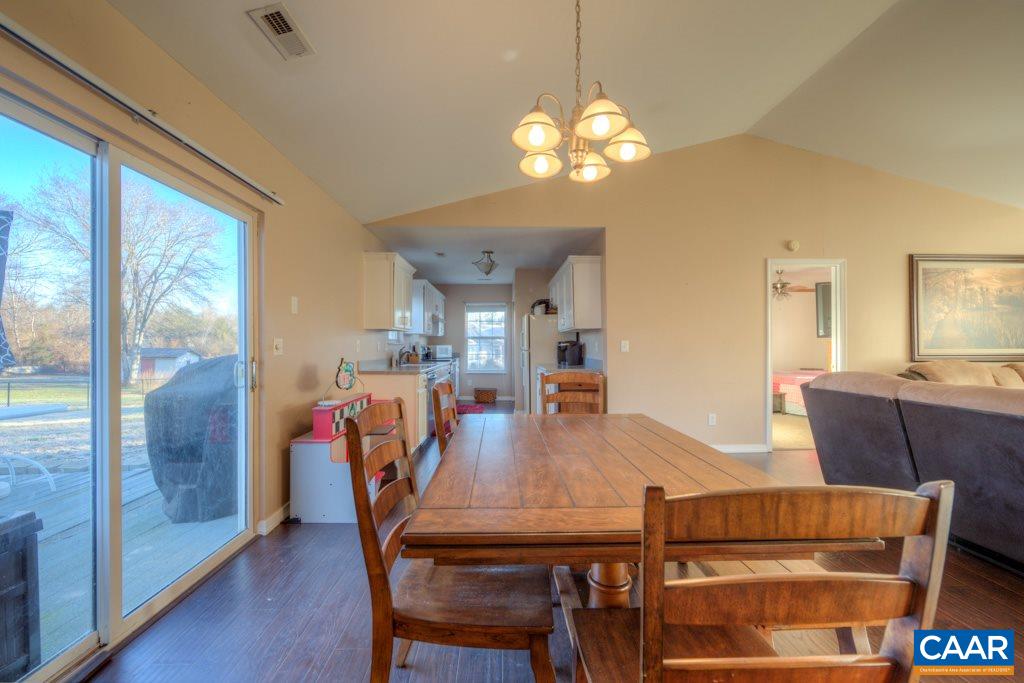 11 Buttercup Road Ruckersville, VA 22968 - Photo 8 of 30 a view of a dining room with furniture and a chandelier
