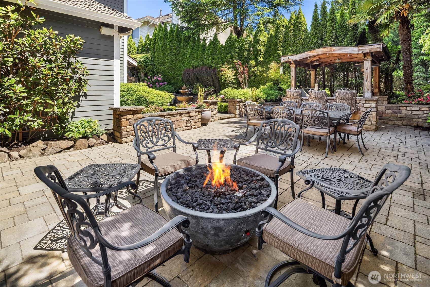 21505 30th Avenue Southeast Bothell, WA 98021 - Photo 28 of 40 a view of a patio with a dining table and chairs with a fire pit