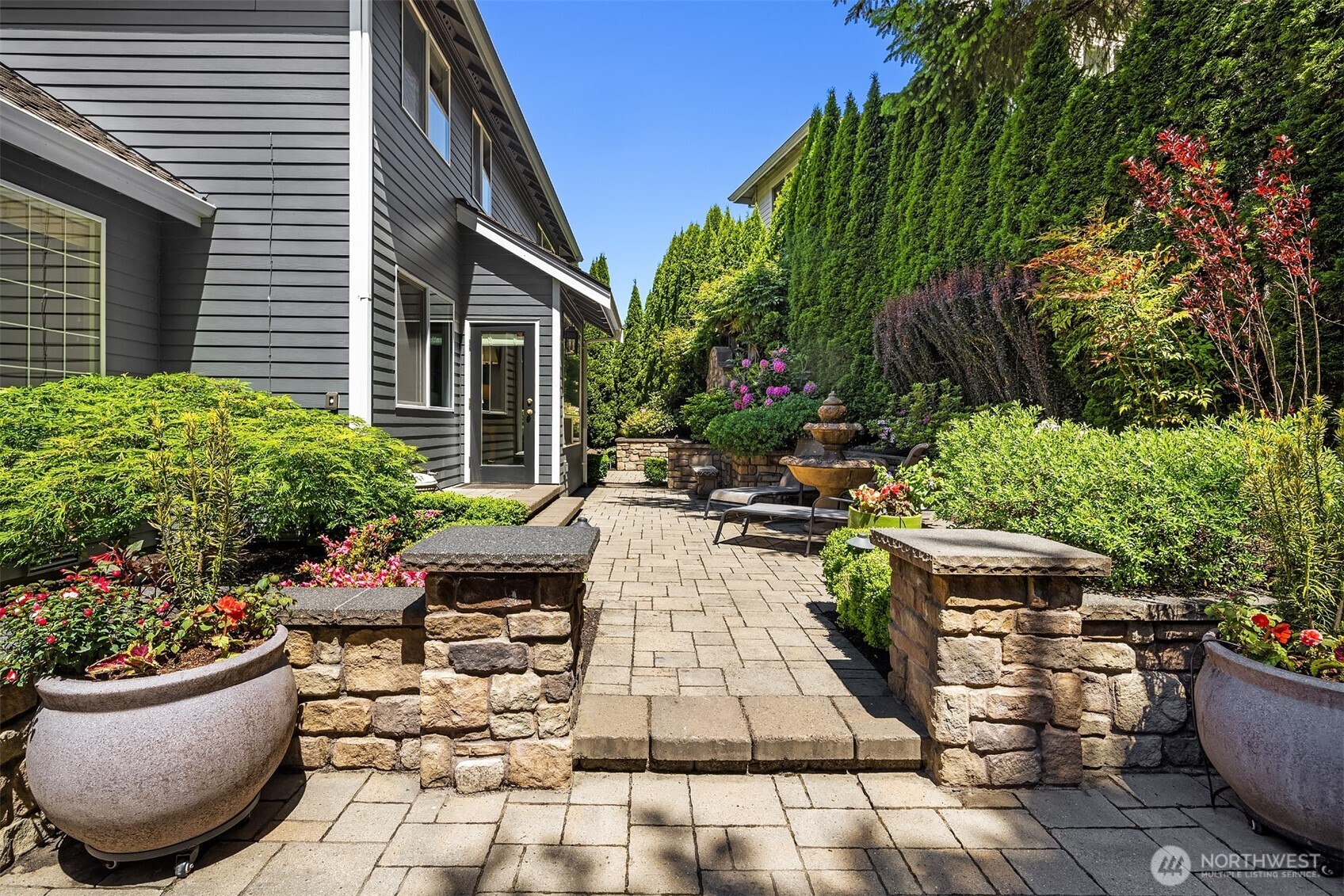 21505 30th Avenue Southeast Bothell, WA 98021 - Photo 29 of 40 a view of a backyard with chair and potted plants