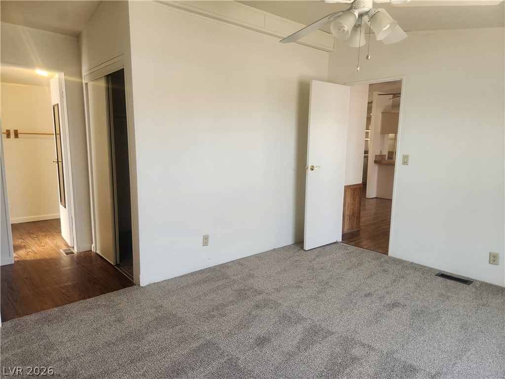 3189 Del Monte Street Laughlin, NV 89029 - Photo 15 of 32 A well-proportioned bedroom features soft carpeting, a ceiling fan, and convenient access to an adjoining space.