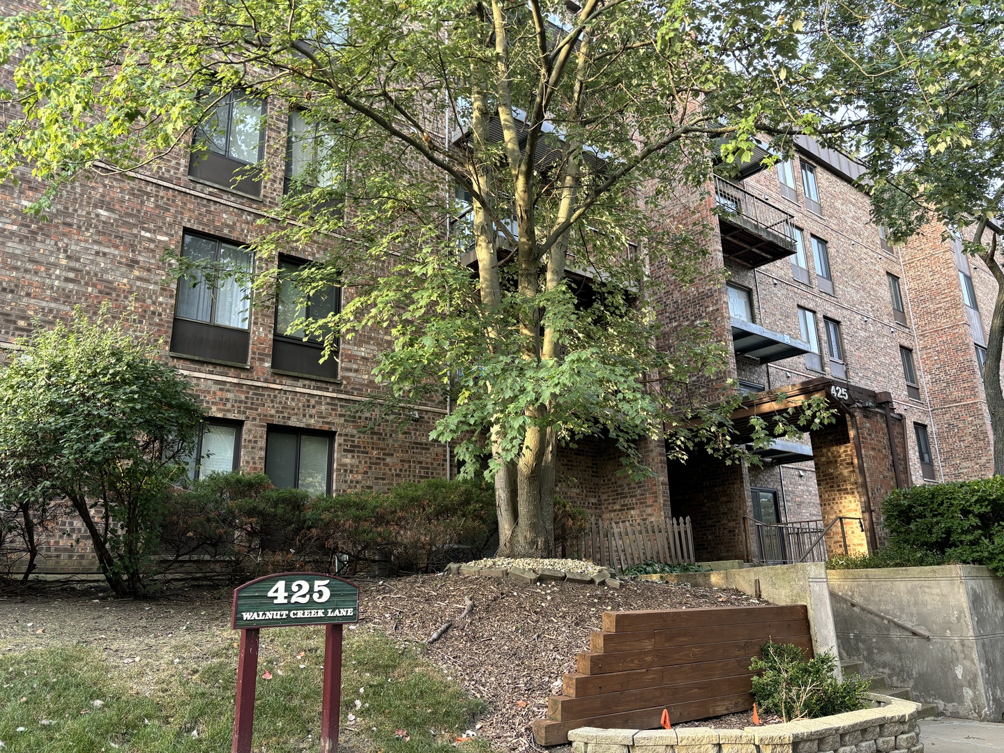 425 Walnut Creek Road, Unit 1207 Lisle, IL 60532 - Photo 1 of 11 a front view of a house with tree s