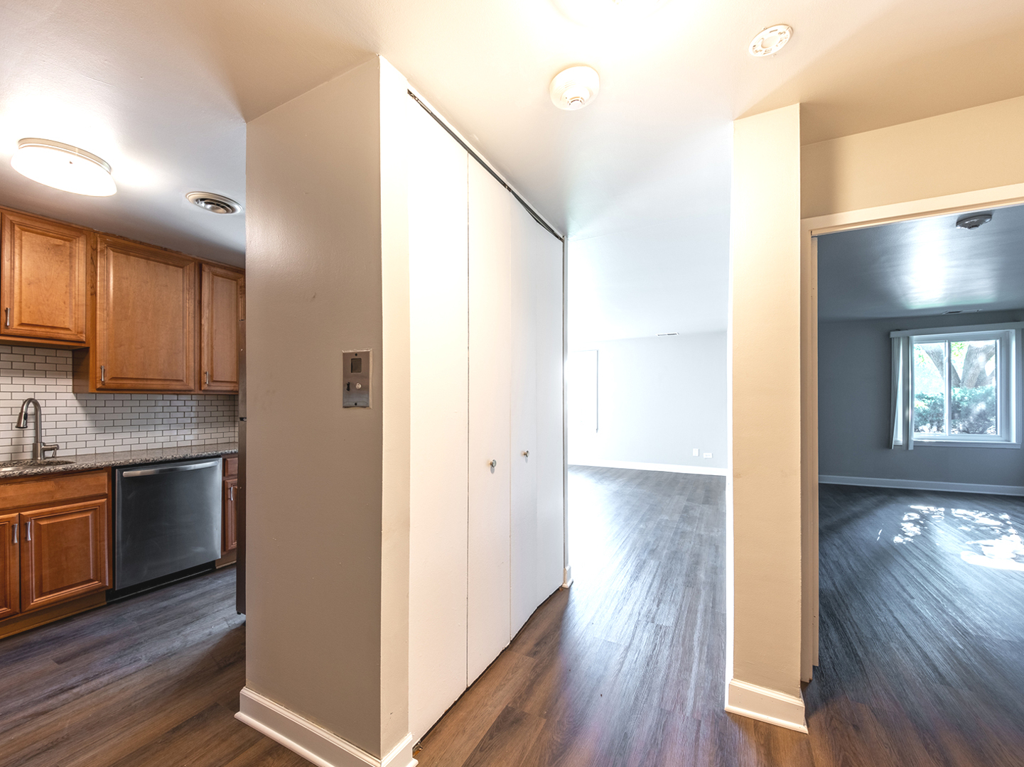 425 Walnut Creek Road, Unit 1207 Lisle, IL 60532 - Photo 2 of 11 a view of a kitchen from the hallway with wooden floor