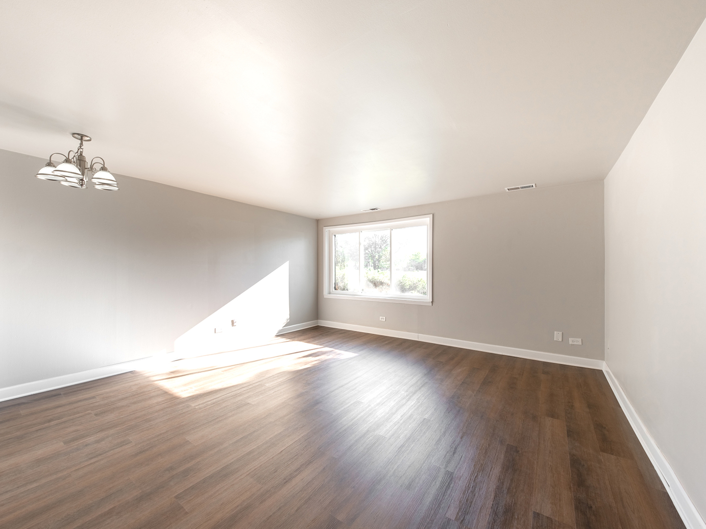 425 Walnut Creek Road, Unit 1207 Lisle, IL 60532 - Photo 5 of 11 an empty room with wooden floor and window