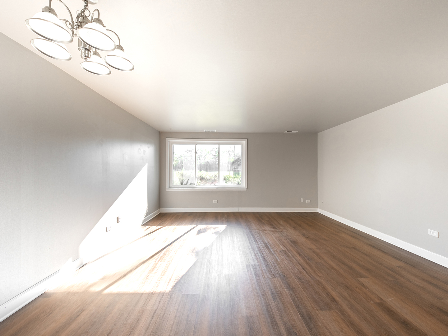 425 Walnut Creek Road, Unit 1207 Lisle, IL 60532 - Photo 6 of 11 an empty room with wooden floor and windows