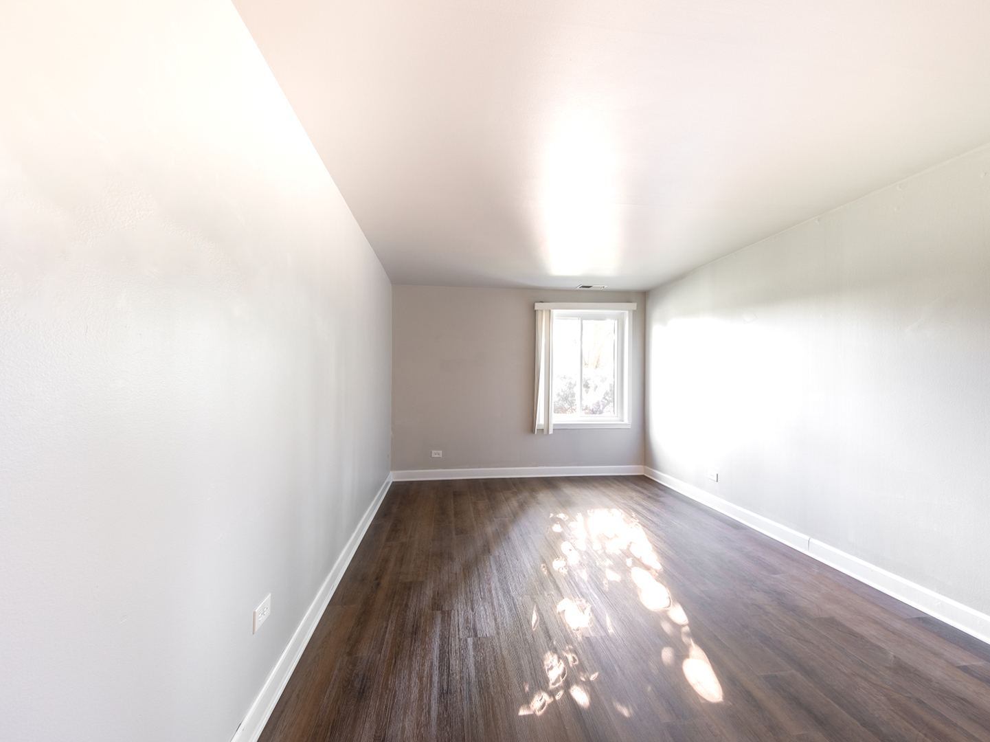 425 Walnut Creek Road, Unit 1207 Lisle, IL 60532 - Photo 7 of 11 an empty room with wooden floor and windows