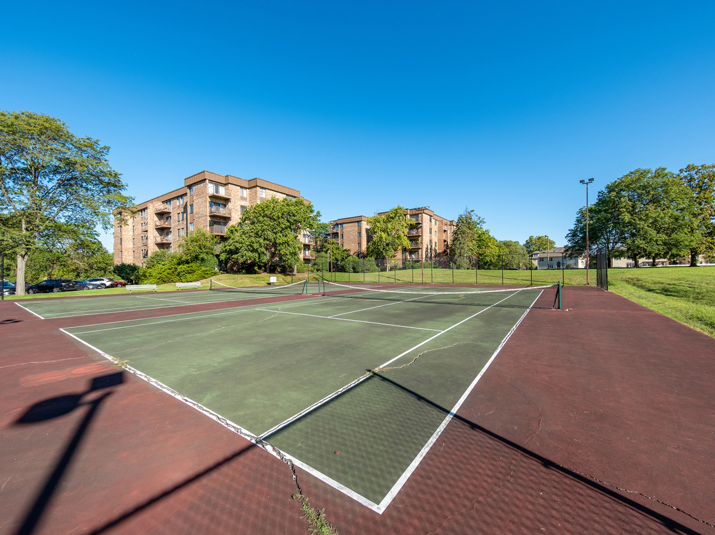 425 Walnut Creek Road, Unit 1207 Lisle, IL 60532 - Photo 9 of 11 a view of a tennis ground with large trees