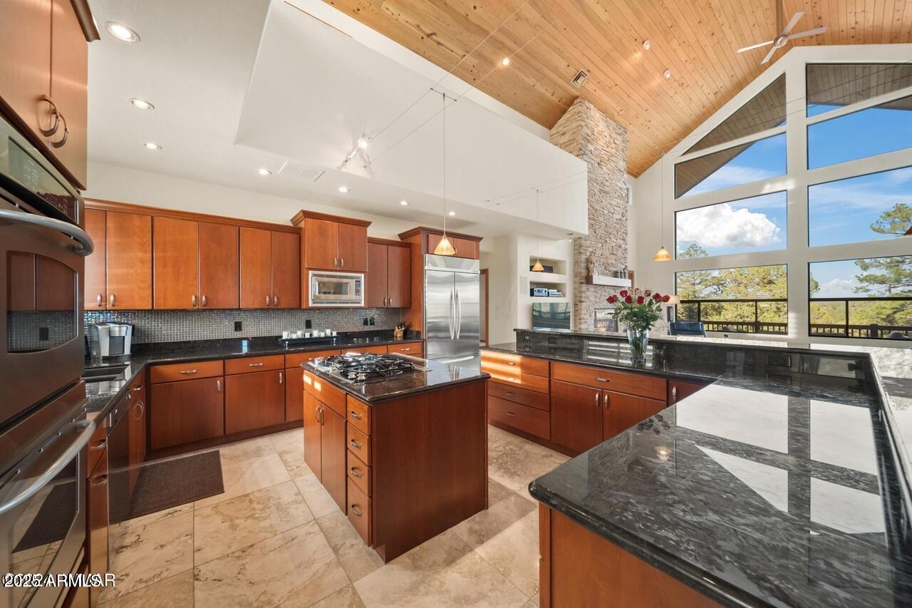 3180 Snowberry Loop Show Low, AZ 85901 - Photo 13 of 101 a large kitchen with stainless steel appliances granite countertop a stove and large window