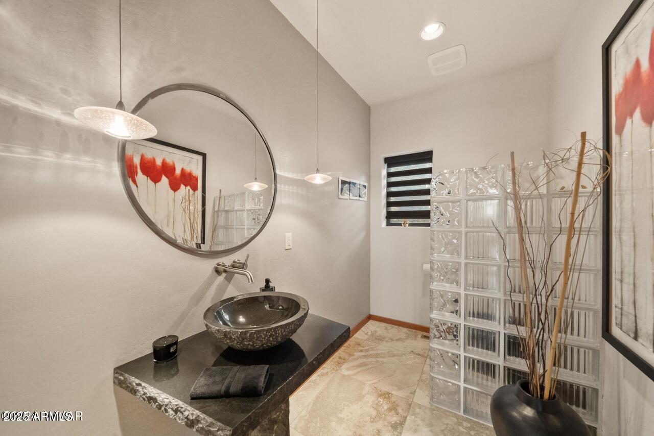 3180 Snowberry Loop Show Low, AZ 85901 - Photo 69 of 101 a bathroom with a sink and a mirror