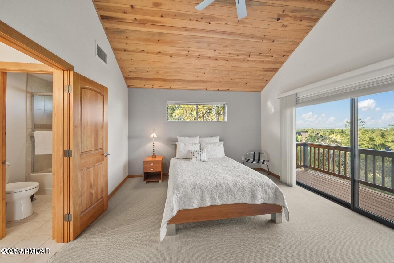 3180 Snowberry Loop Show Low, AZ 85901 - Photo 71 of 101 a spacious bedroom with a bed and a chandelier