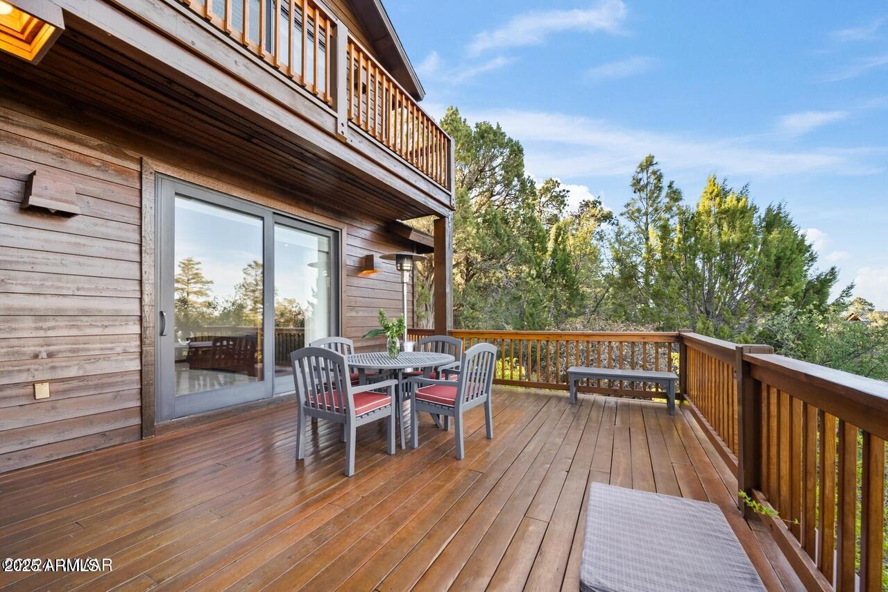 3180 Snowberry Loop Show Low, AZ 85901 - Photo 88 of 101 a balcony with wooden floor table and chairs