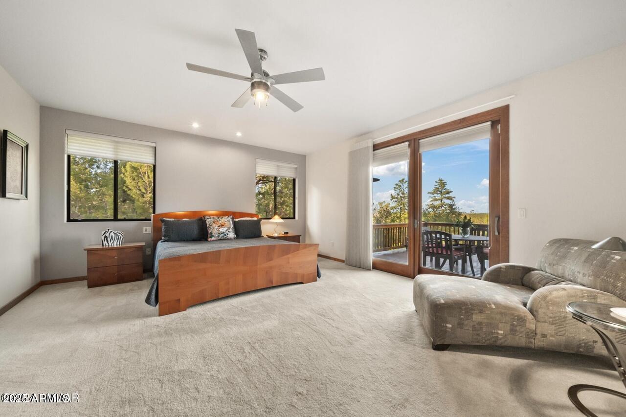 3180 Snowberry Loop Show Low, AZ 85901 - Photo 100 of 101 a bedroom with a large bed and a couch