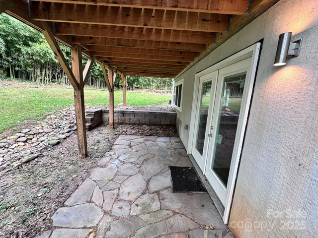 a view of a house with backyard porch and sitting area