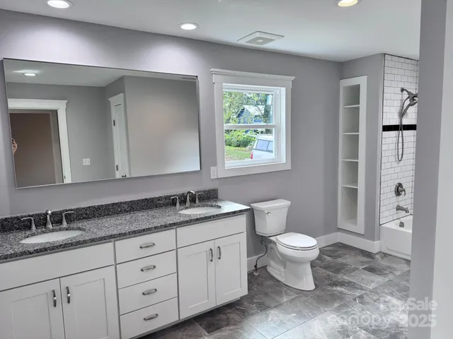a bathroom with a bathtub and shower