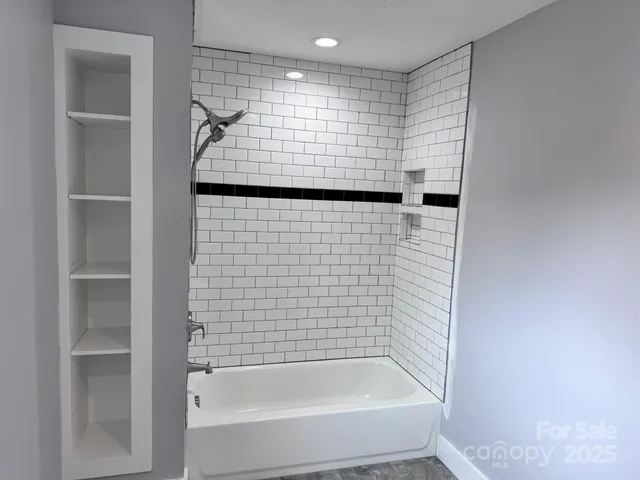 a view of empty room with window and ceiling fan