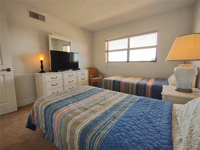 a bedroom with double bed and a flat screen tv