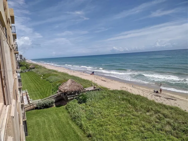 a view of a field with an ocean