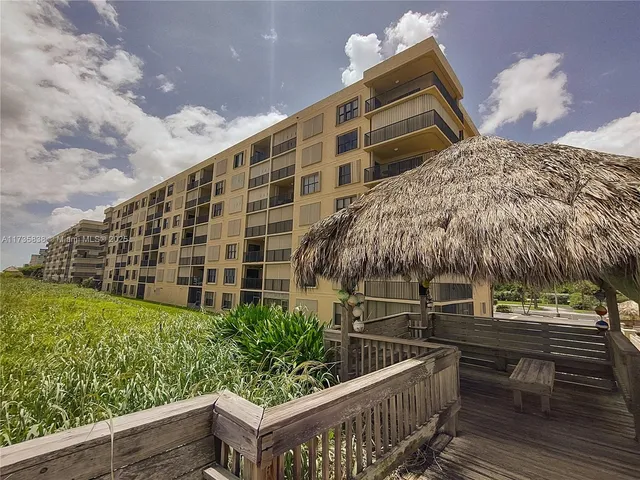 a view of building with yard and staircase