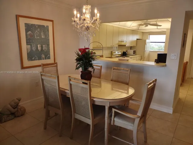 a view of a dining room with furniture and a chandelier