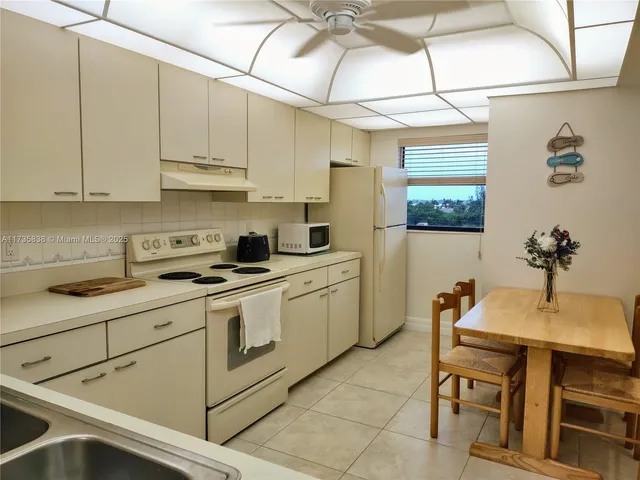 a kitchen with a sink cabinets and window