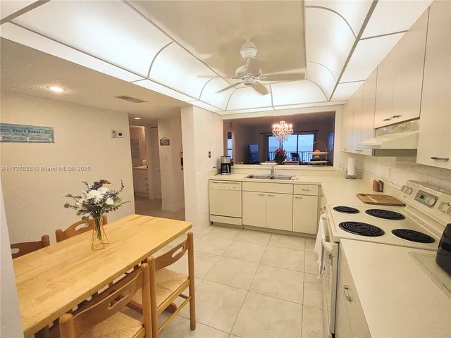 a kitchen that has a lot of cabinets in it and appliances