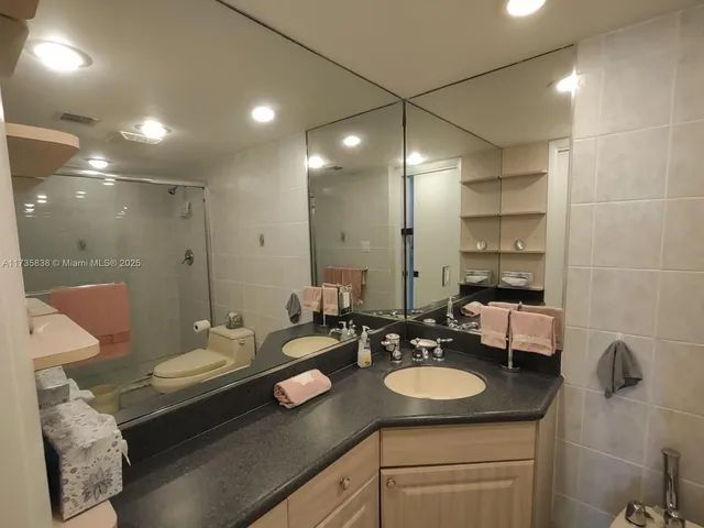 a bathroom with a sink double vanity granite and a mirror