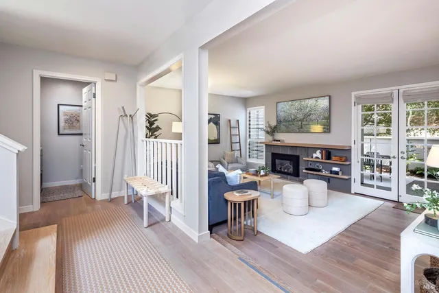 a living room with furniture a fireplace and a table