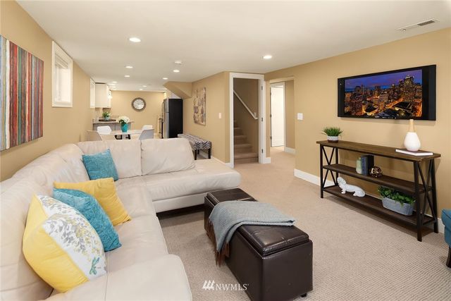 a kitchen with sink attached with living room