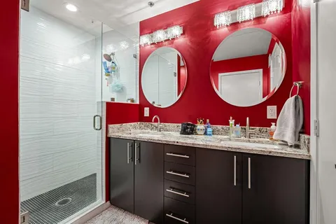 a bedroom with a large bed and a chandelier