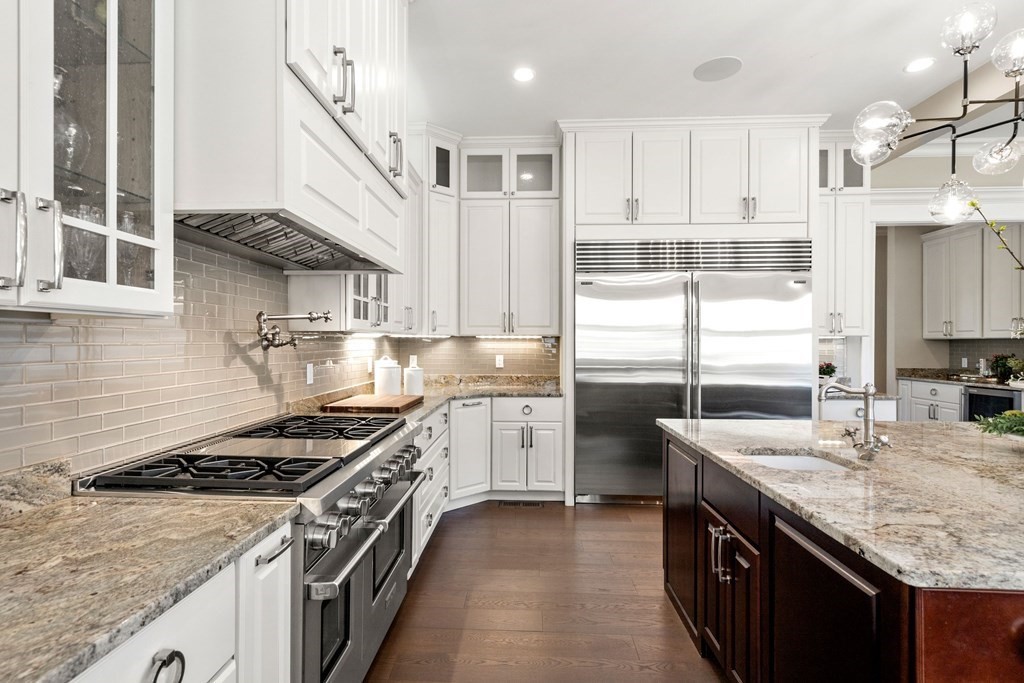 9 Nardell Road Newton, MA 02459 - Photo 4 of 32 a kitchen with stainless steel appliances granite countertop a sink stove and refrigerator