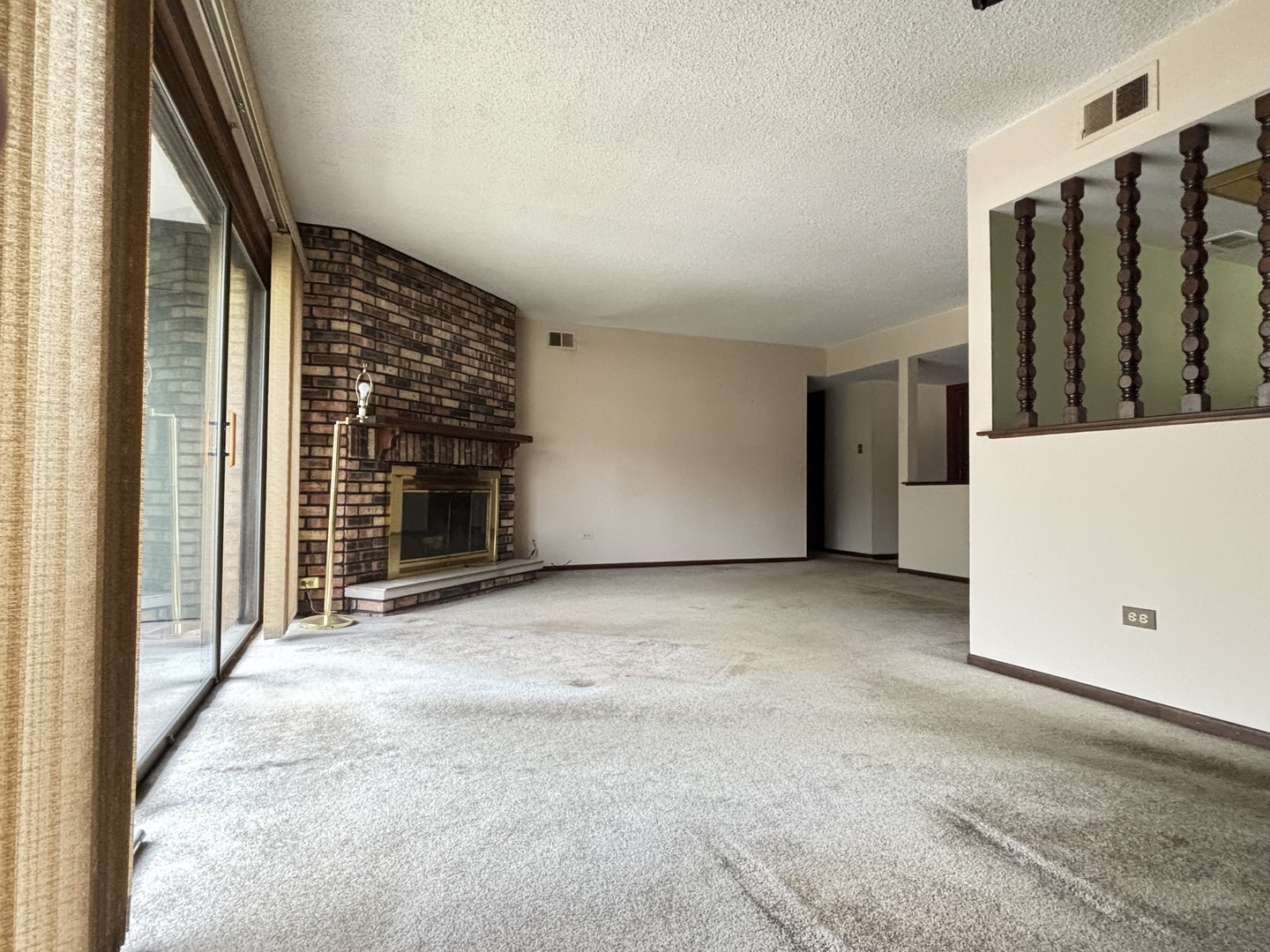9168 S Road, Unit A Palos Hills, IL 60465 - Photo 3 of 14 a view of an empty room with a fireplace