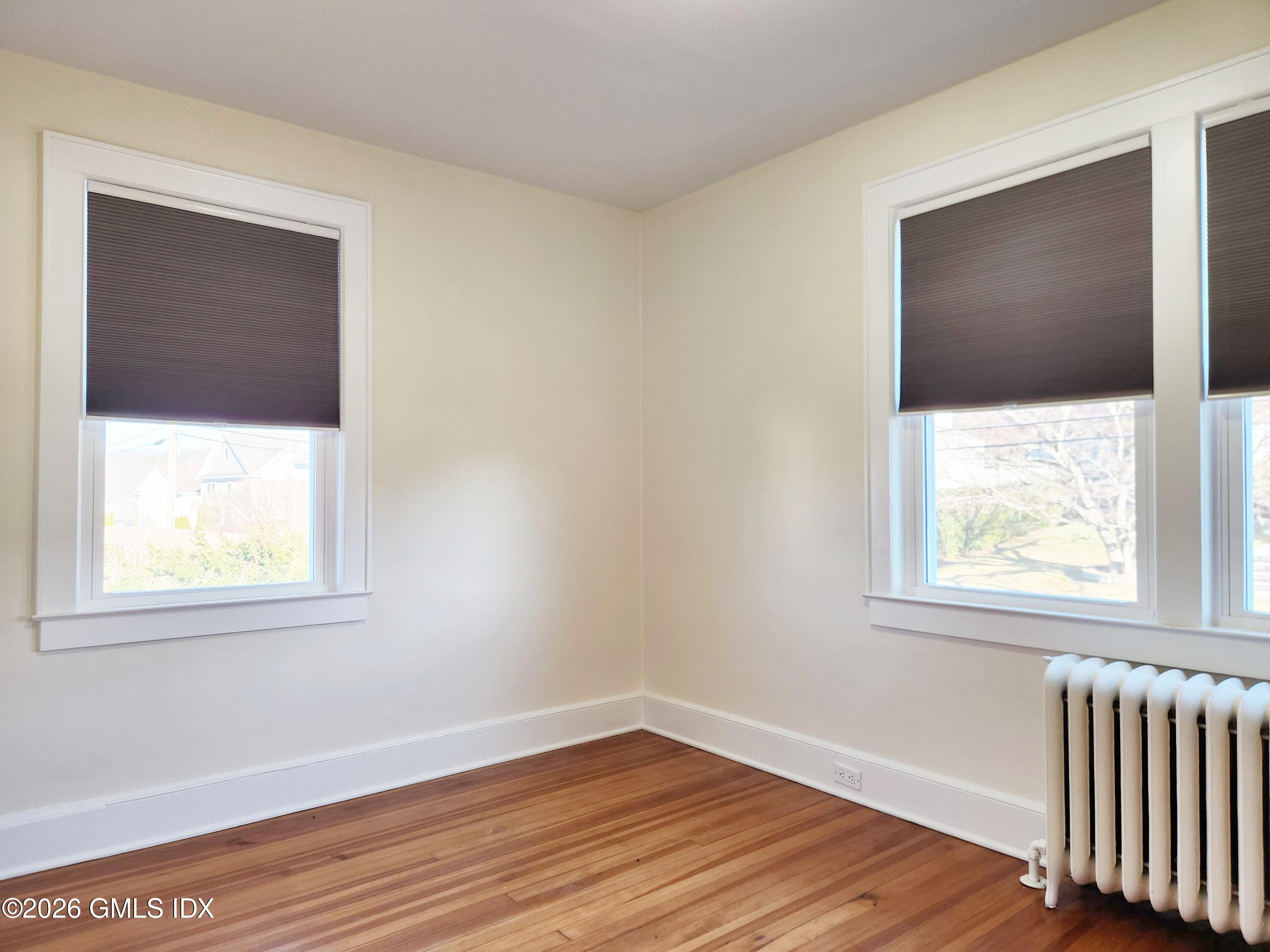 34 Harold Street Cos Cob, CT 06807 - Photo 16 of 25 an empty room with wooden floor and windows