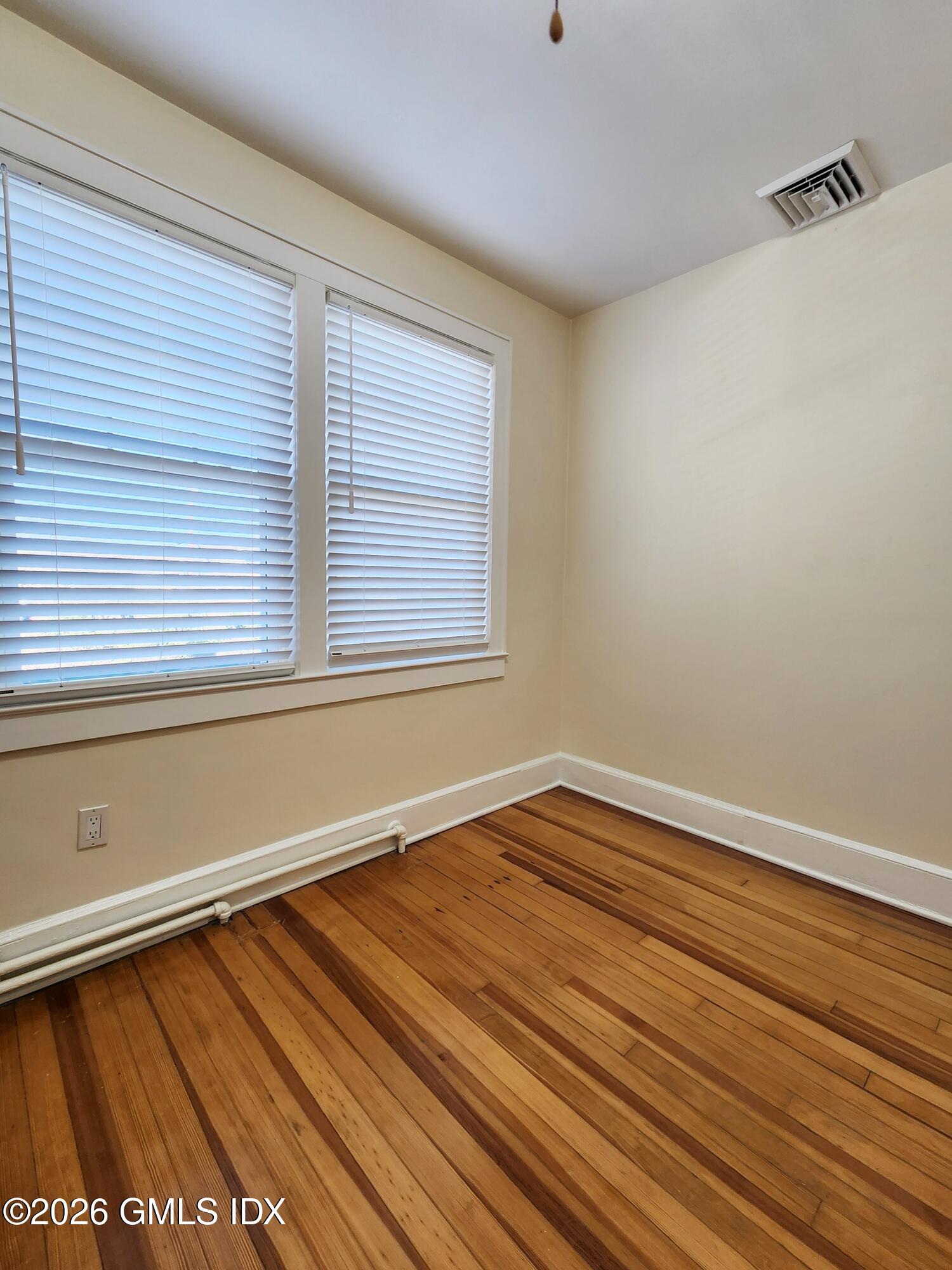 34 Harold Street Cos Cob, CT 06807 - Photo 17 of 25 a view of an empty room with wooden floor and a window