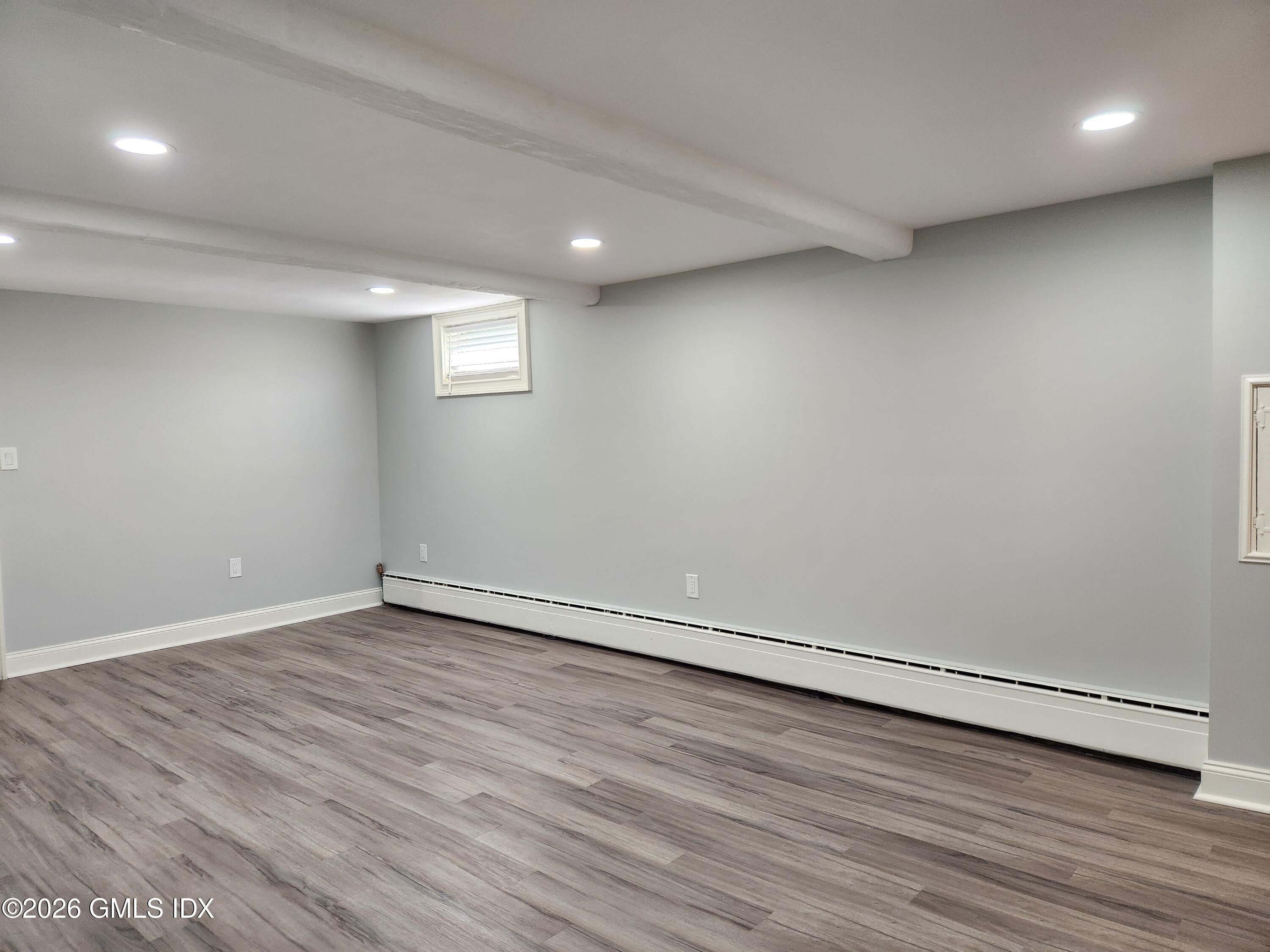 34 Harold Street Cos Cob, CT 06807 - Photo 19 of 25 an empty room with wooden floor and windows