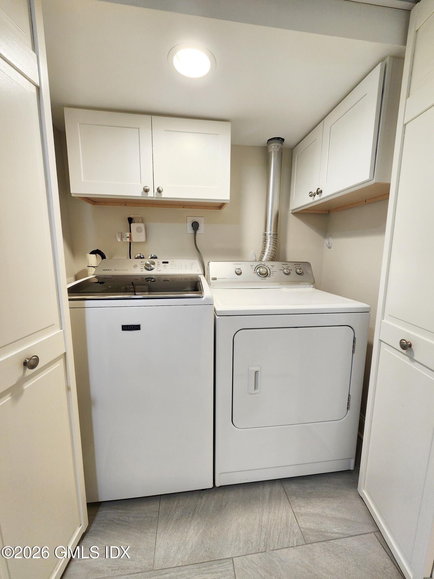 34 Harold Street Cos Cob, CT 06807 - Photo 22 of 25 a utility room with cabinets washer and dryer